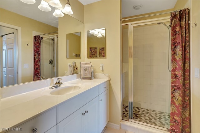 bathroom with tile patterned flooring, vanity, and a shower with door