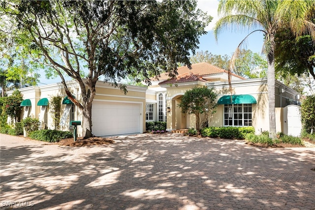 mediterranean / spanish-style house with a garage