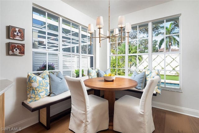 dining space with an inviting chandelier and wood-type flooring