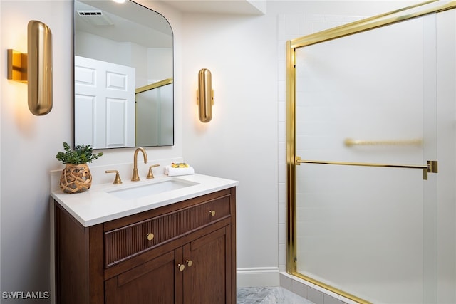 bathroom featuring vanity and a shower with shower door