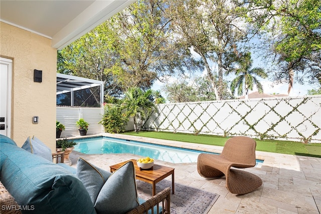 view of swimming pool with a patio and a lanai