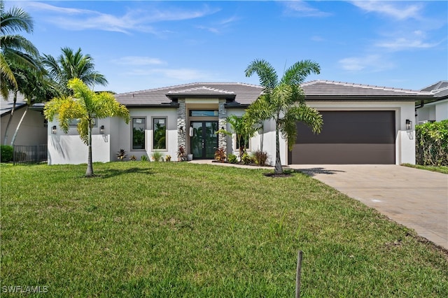 view of front of home featuring french doors, a garage, and a front lawn