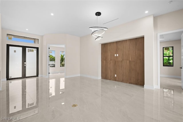 foyer featuring a chandelier