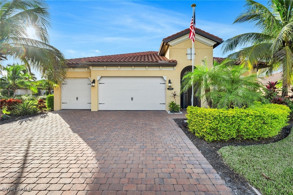 mediterranean / spanish home featuring a garage