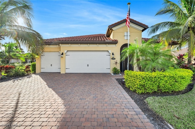 mediterranean / spanish home featuring a garage