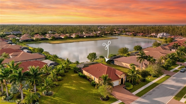 aerial view at dusk with a water view