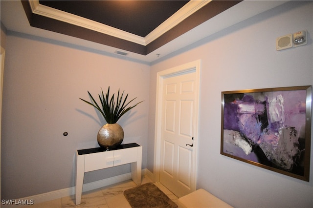 interior space featuring crown molding and a tray ceiling