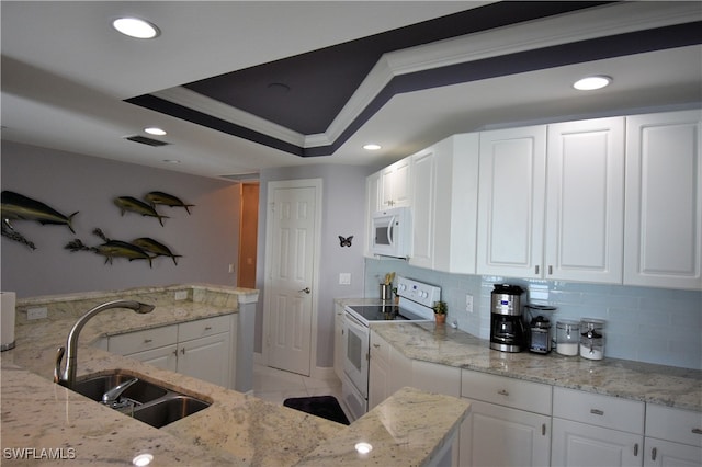 kitchen with white cabinetry, crown molding, white appliances, and sink