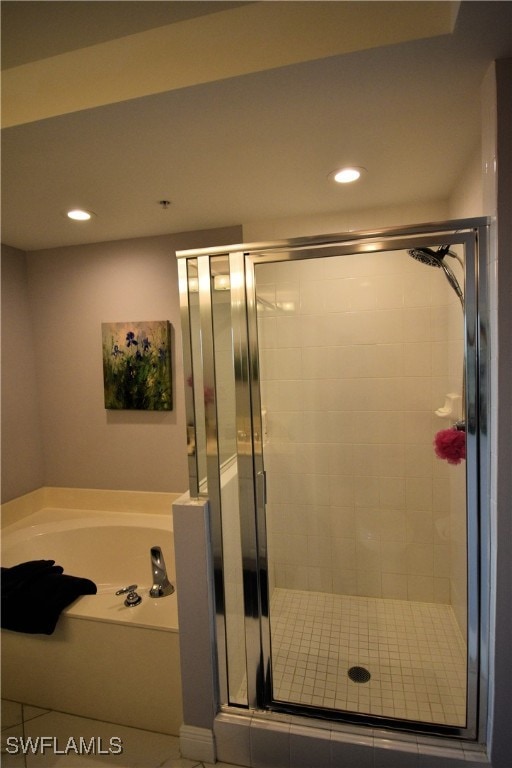 bathroom featuring separate shower and tub