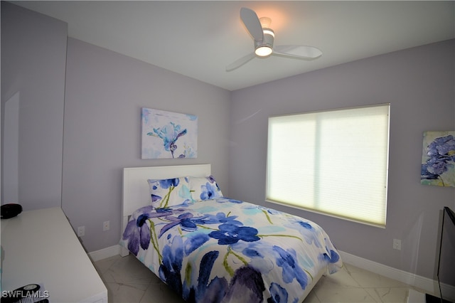 bedroom featuring ceiling fan and multiple windows