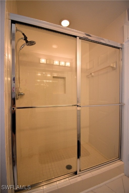 bathroom with tile patterned floors and walk in shower