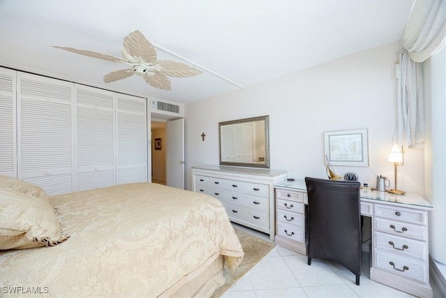 bedroom featuring ceiling fan, light tile patterned flooring, and a closet