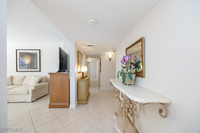 hall featuring light tile patterned flooring