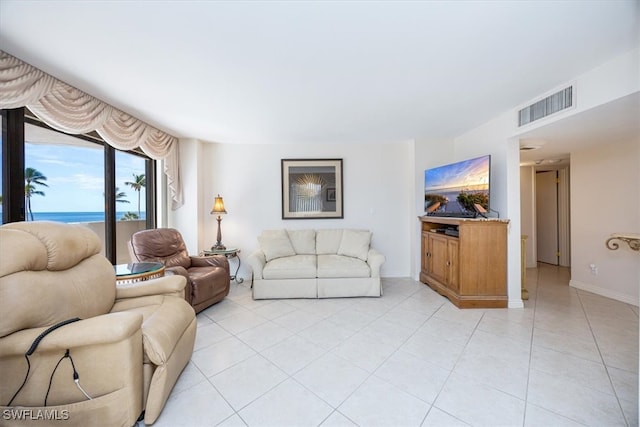 tiled living room with a water view