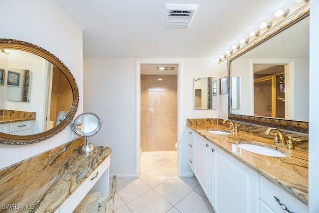 bathroom with tile patterned flooring, vanity, and toilet