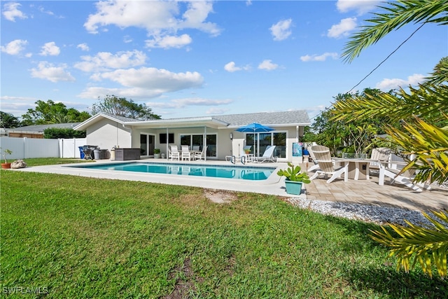 view of swimming pool featuring a patio and a lawn