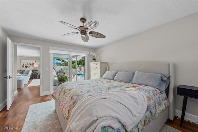 bedroom with dark wood-type flooring, ceiling fan, access to exterior, and a textured ceiling