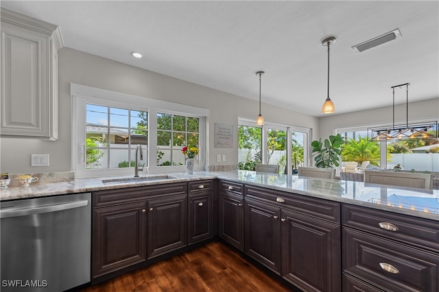 kitchen featuring dishwasher, sink, pendant lighting, and dark brown cabinetry