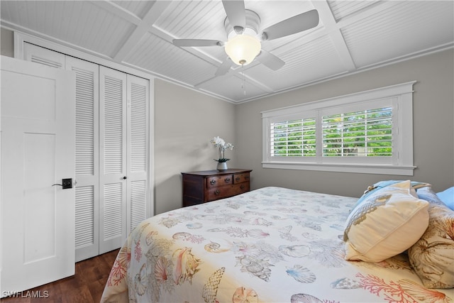 bedroom with dark wood-type flooring, ceiling fan, beam ceiling, coffered ceiling, and a closet