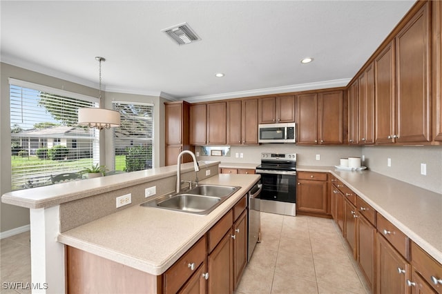 kitchen featuring stainless steel appliances, sink, ornamental molding, a kitchen island with sink, and pendant lighting