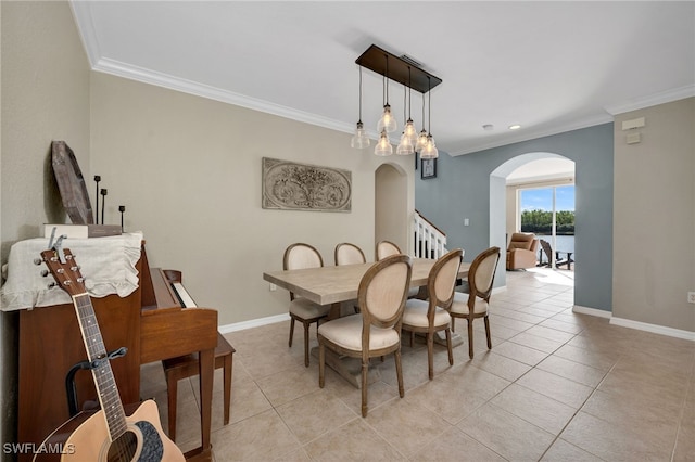 tiled dining area featuring ornamental molding