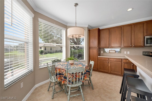 tiled dining space with a wealth of natural light, a chandelier, and ornamental molding