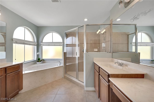 bathroom with independent shower and bath, vanity, and tile patterned floors