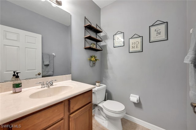 bathroom featuring toilet, vanity, and tile patterned floors