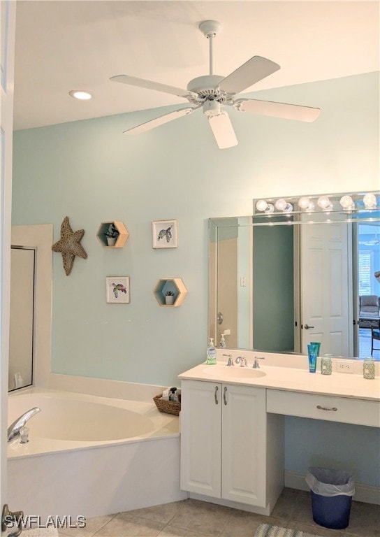 bathroom featuring tile patterned floors, a tub, ceiling fan, and vanity