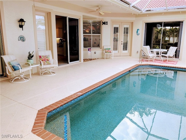 view of swimming pool featuring ceiling fan and a patio