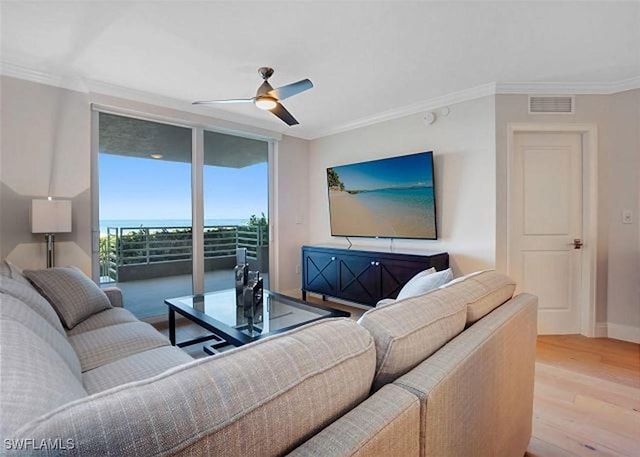 living room featuring light wood-type flooring, expansive windows, ceiling fan, and ornamental molding