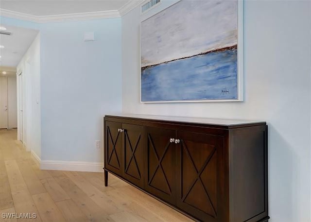 hallway with crown molding and light wood-type flooring