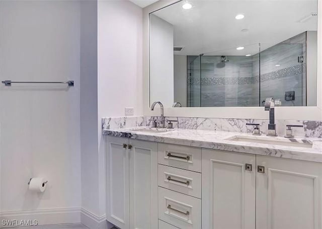 bathroom featuring vanity and a shower with door