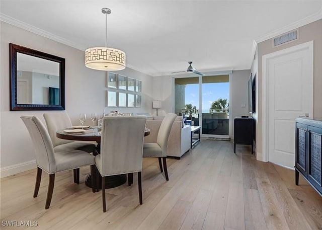 dining room featuring ceiling fan, crown molding, and light hardwood / wood-style floors