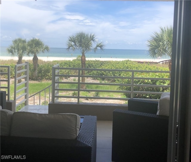 balcony featuring a water view and a view of the beach