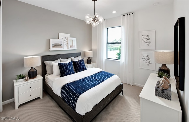 bedroom featuring light colored carpet and a notable chandelier