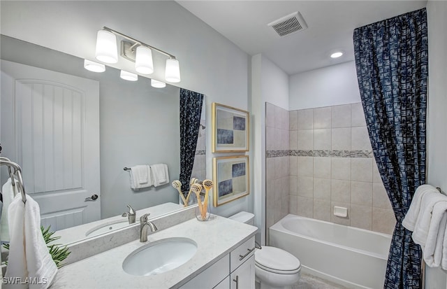 full bathroom featuring shower / bath combo, vanity, and toilet