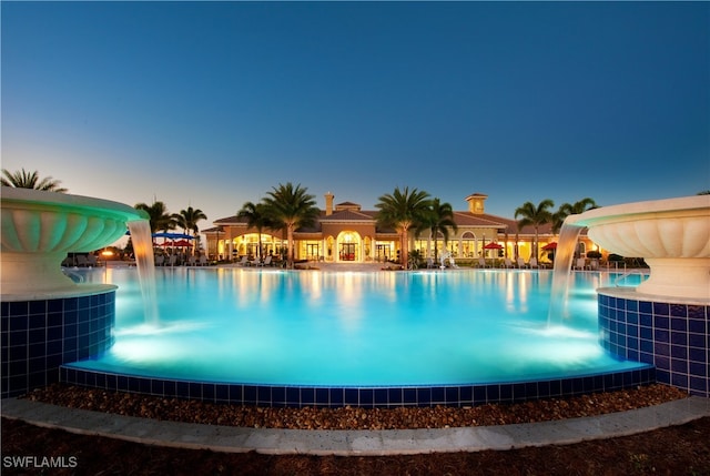 pool at dusk with a water slide