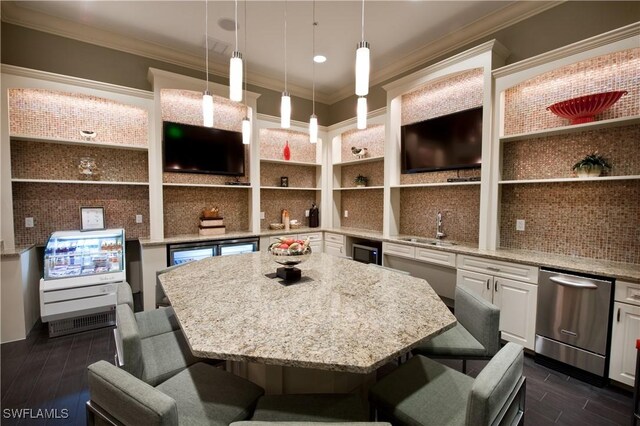 kitchen with a kitchen island, hanging light fixtures, a kitchen breakfast bar, and white cabinets