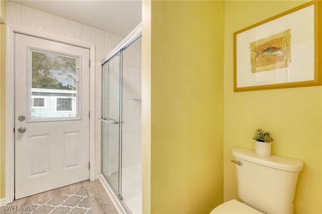 bathroom with an enclosed shower and toilet