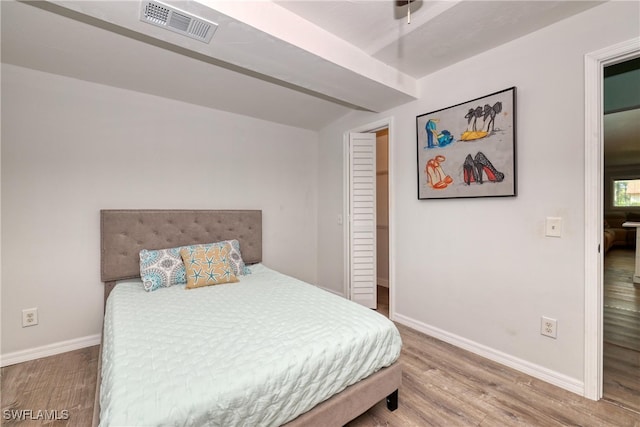 bedroom with hardwood / wood-style floors