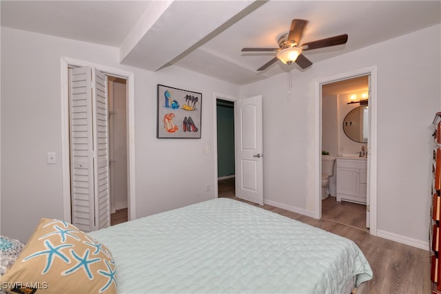 bedroom featuring a closet, ceiling fan, hardwood / wood-style floors, and ensuite bath