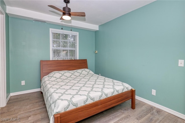 bedroom with ceiling fan and hardwood / wood-style flooring