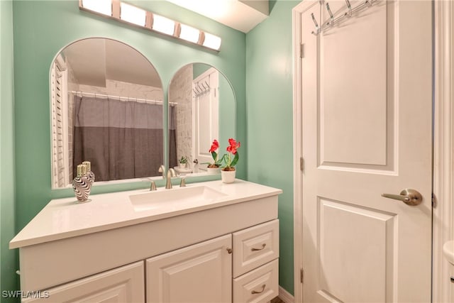 bathroom with curtained shower and vanity