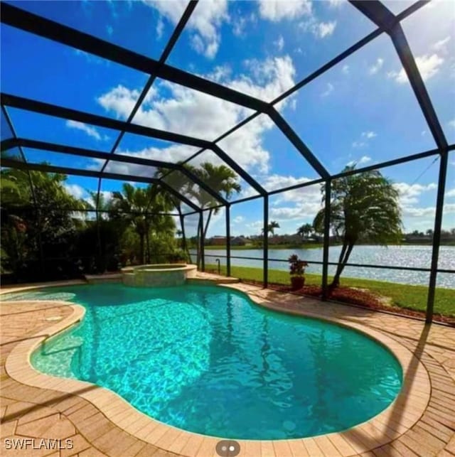 view of pool with a lanai, a water view, and a patio area