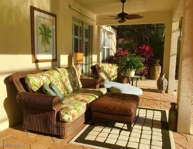 sunroom / solarium featuring ceiling fan