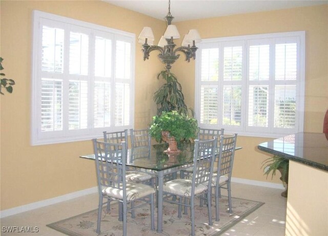 dining room featuring tile patterned flooring and an inviting chandelier