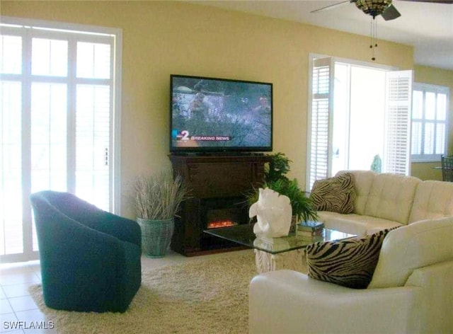 living room with tile patterned floors and ceiling fan