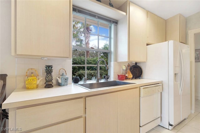 kitchen featuring dishwasher, tasteful backsplash, light tile patterned flooring, and sink