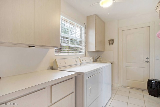 laundry area with ceiling fan, sink, cabinets, separate washer and dryer, and light tile patterned floors